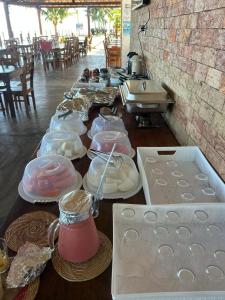 a long table with plates of food on it at Pousada Algas Marinhas in Mangue Sêco