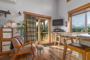 a kitchen and living room with a view of a mountain at Little Big Fish | Wifi, BBQ, AC ,Rainier View in Packwood