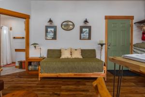 a living room with a couch and a green door at Little Big Fish | Wifi, BBQ, AC ,Rainier View in Packwood