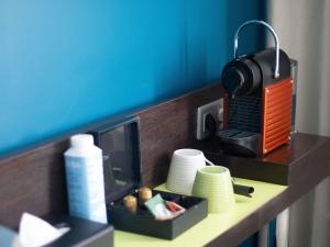 a kitchen counter with a toaster and dishes on it at ibis Styles Evry Courcouronnes Hotel and Events in Courcouronnes +83 photos