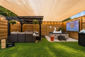 a backyard with a pool with a swan and a pergola at Downtown Luxe Retreat - King Bed, Pool, Pong, Billiards, Grill & FREE Coffee in Houston