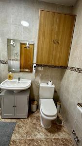 a bathroom with a toilet and a sink at AMANECER ZEN in Argés +9 photos