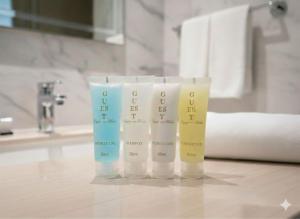 three tubes of toothbrushes sitting on a bathroom counter at SAkura Hotel Astara in Astara +64 photos