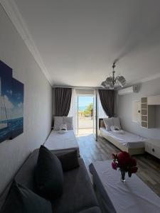 a living room with two beds and a couch at SAkura Hotel Astara in Astara