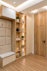 a room with wooden shelves and a door at Sapphire Residence in Khujand