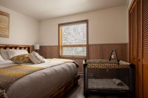 a bedroom with a bed and a window at Ask us for our immersive 3D virtual tour before reservation in Lac-Superieur