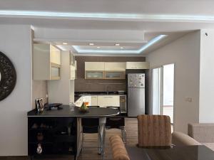 a kitchen with a table and a refrigerator in a room at Villa cornich in Banzart +16 photos