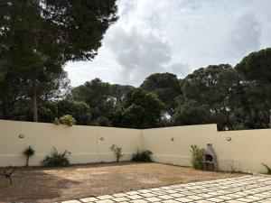 a white fence with trees in the background at Villa cornich in Banzart