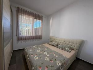 a bedroom with a bed and a window at Beach Garden Home, Lalzi Bay in Draç