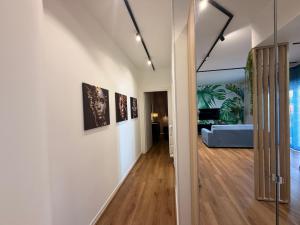 a hallway leading to a living room with white walls at Lo Snodo Apartments cucina e parcheggio in Pomigliano dʼArco
