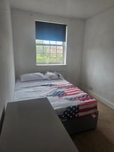 a bed in a room with a window at Ramsgate Cozy Home in Ramsgate