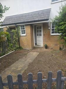 a brick house with a door and a fence at Ramsgate Cozy Home in Ramsgate