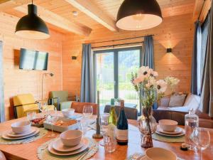 a dining room with a table with flowers on it at Rattendorf 15B in Rattendorf