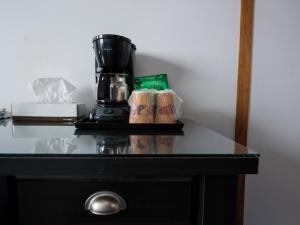 a coffee maker sitting on top of a table at Sea Breeze Motel in Ingonish