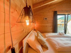 a bedroom with a bed in a wooden wall at Rattendorf 20A in Rattendorf