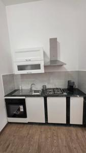 a kitchen with a sink and a stove at Mari del sud in Bagheria