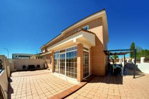 a brick building with a large glass door at AMANECER ZEN in Argés