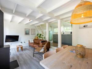 a living room with a table and a couch at De Nordic Escape in Warmenhuizen