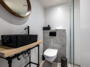 a bathroom with a toilet and a mirror at De Nordic Escape in Warmenhuizen +30 photos