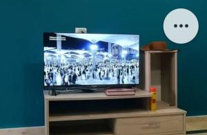 a flat screen tv sitting on top of a stand at Seaside Mediterranean Duplex in Kelibia