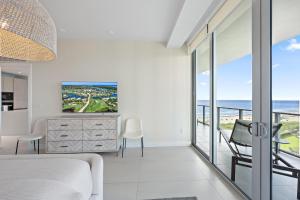 a bedroom with a view of the ocean at Amrit Resort - Bask in Rare Oceanfront Luxury with Stunning Views in Riviera Beach
