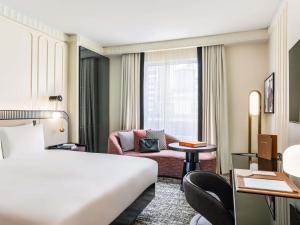 a hotel room with a bed and a couch at Sofitel New York in New York +185 photos