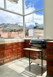 a room with a window with a barber chair in front at Munay Wasy Carhuaz in Carhuaz +4 photos