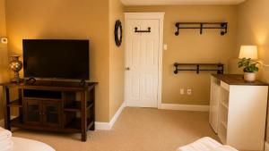 a living room with a flat screen tv on a table at Private Two Queen Beds Room Near UPEI & Downtown Cozy Retreat Near Everything in Charlottetown