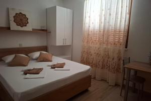 a bedroom with a bed with two towels on it at Apartments with parking space Igrane, Makarska - 13535 in Igrane