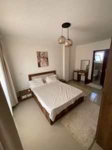 a bedroom with a large bed and a mirror at شقه في مدينتي غرفتين و صاله مكيفه مفروشه فندقي - Fully Furnished & Air-Conditioned 2-Bedroom Apartment with Large Living Room in Madinaty - 98 sqm in Madinaty