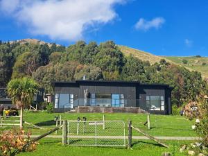 a house on the side of a mountain at Christchurch - Port Levy, Bed & Breakfast in Port Levy