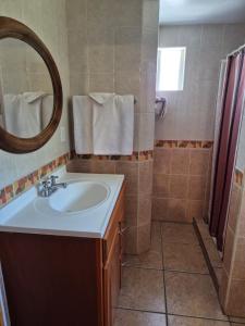 a bathroom with a sink and a mirror at Hotel Lorimar in La Paz +24 photos
