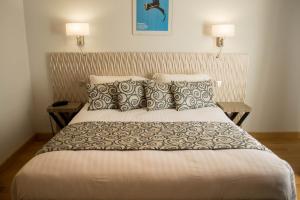 a bedroom with a large bed with two pillows at Hôtel Restaurant Des Remparts in Chaumont +39 photos