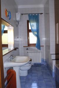a bathroom with a sink and a toilet and a window at B&B Tramonti sull'Adriatico in Muggia +38 photos