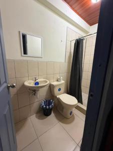 a bathroom with a toilet and a sink at Hostal Calle Real in León +43 photos