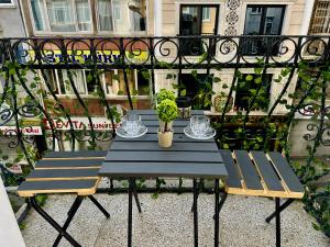 a table and two chairs on a balcony at Asil house in Istanbul