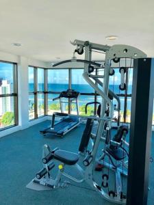 a room with a gym with a view of the ocean at Flat Aconchego Olinda - Vista e Piscina in Olinda