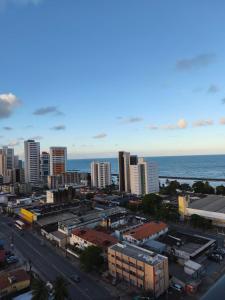 a view of a city with buildings and the ocean at Flat Aconchego Olinda - Vista e Piscina in Olinda