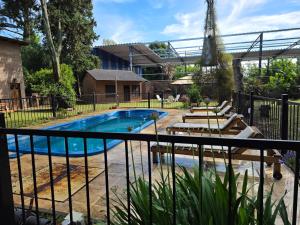 a pool in a yard with a fence at Los Cabre in San Pedro