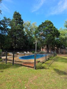 a fence in a yard with a swimming pool at Los Cabre in San Pedro +14 photos