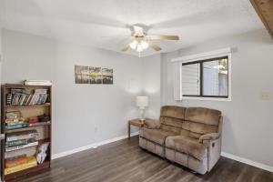 a living room with a couch and a ceiling fan at Private Dock-Deck-LakeHouse-Lake Front-3bd 2bth in Lake Ozark