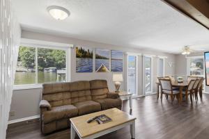 a living room with a couch and a table at Private Dock-Deck-LakeHouse-Lake Front-3bd 2bth in Lake Ozark