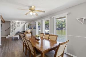 a dining room with a table and chairs at Private Dock-Deck-LakeHouse-Lake Front-3bd 2bth in Lake Ozark