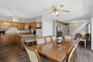 a kitchen and dining room with a wooden table and chairs at Private Dock-Deck-LakeHouse-Lake Front-3bd 2bth in Lake Ozark +21 photos
