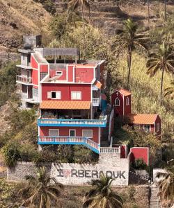 a house on top of a hill with palm trees at I Love Tanque in Caculi