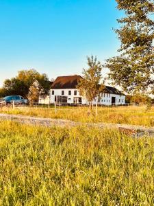 a field of grass with a house in the background at The Sanctuary with private Jacuzzi in České Budějovice