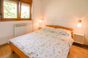a bedroom with a bed and a window at Apartment Smoljanac 14979b in Smoljanac