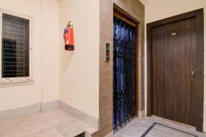 a brown door in a room with a window at Super Collection O Gariahat Kolkata Formerly 6 Seasons in Kolkata