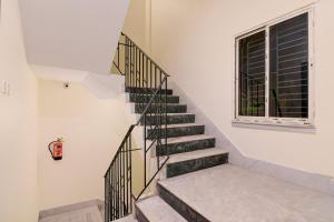 a staircase in a house with a window at Super Collection O Gariahat Kolkata Formerly 6 Seasons in Kolkata