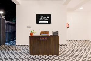 a reception desk with a sign on a wall at Super Collection O Gariahat Kolkata Formerly 6 Seasons in Kolkata